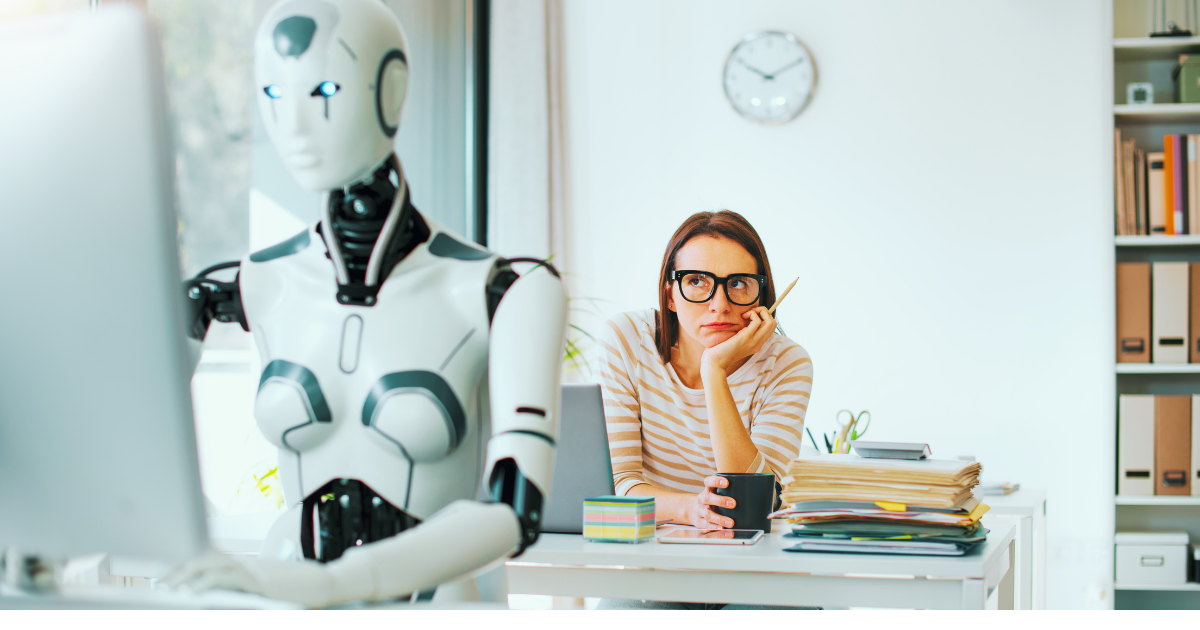 Robot working at a computer while a bored marketer sits idle, illustrating an AI reply generator handling social media comments